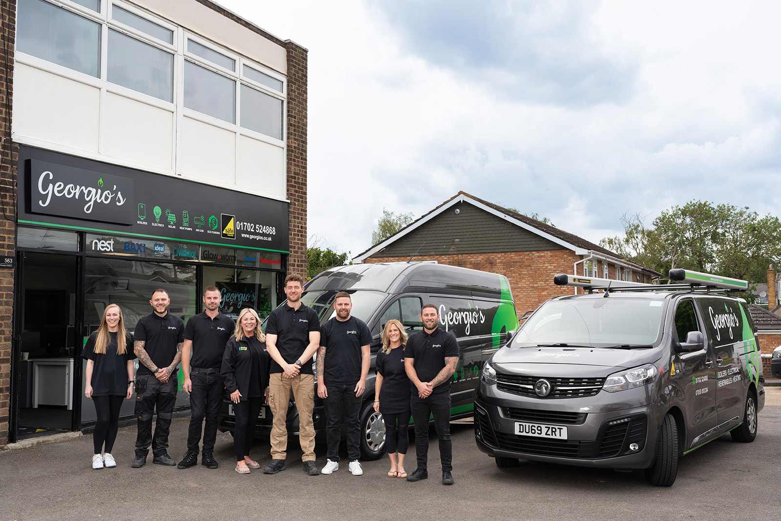 The Georgio's team outside their Leigh-on-Sea office with branded vans